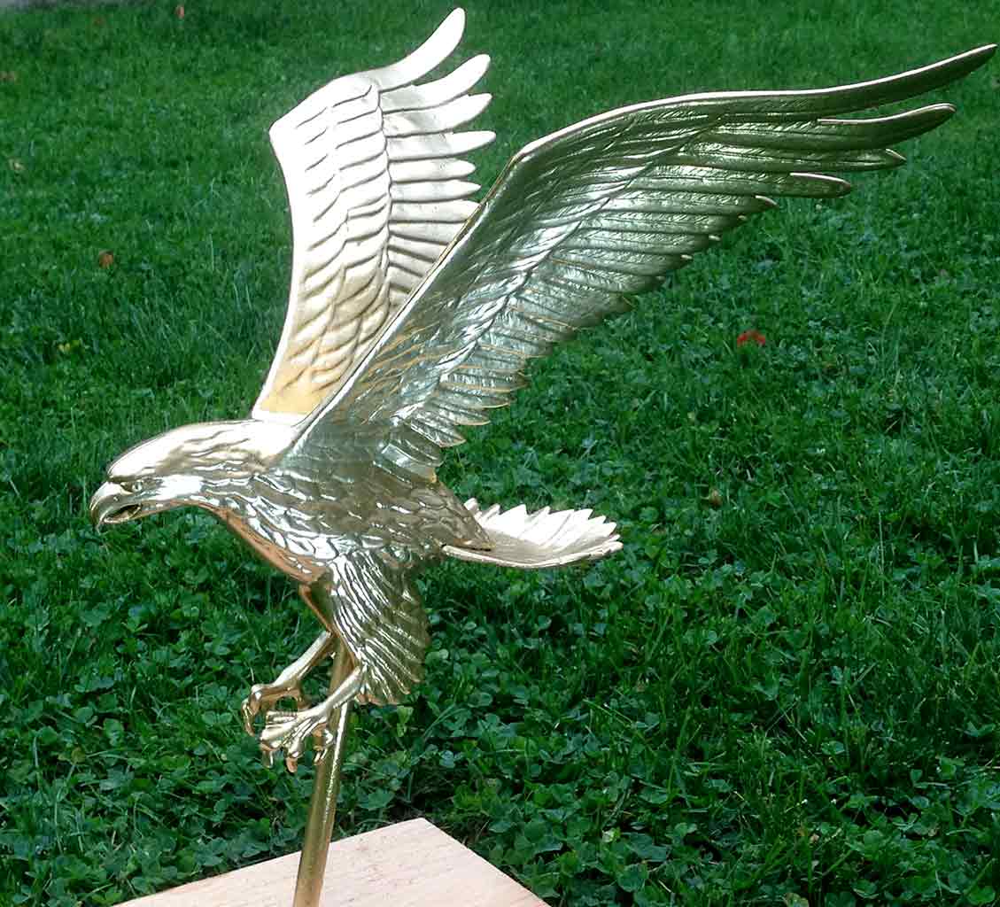 Owner restores eagle with gold leaf