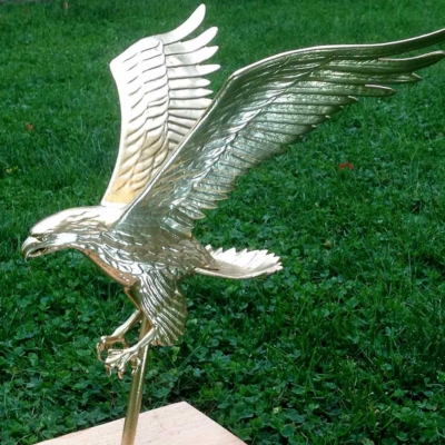 Owner restores eagle with gold leaf